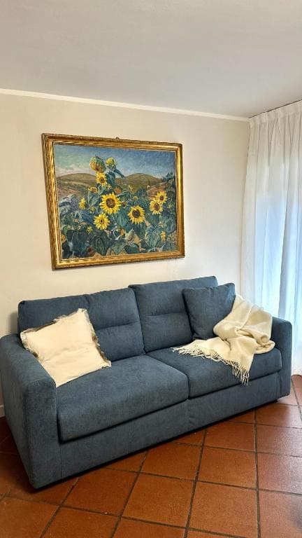 Living Area: Blue Sofa & Sunflower Art